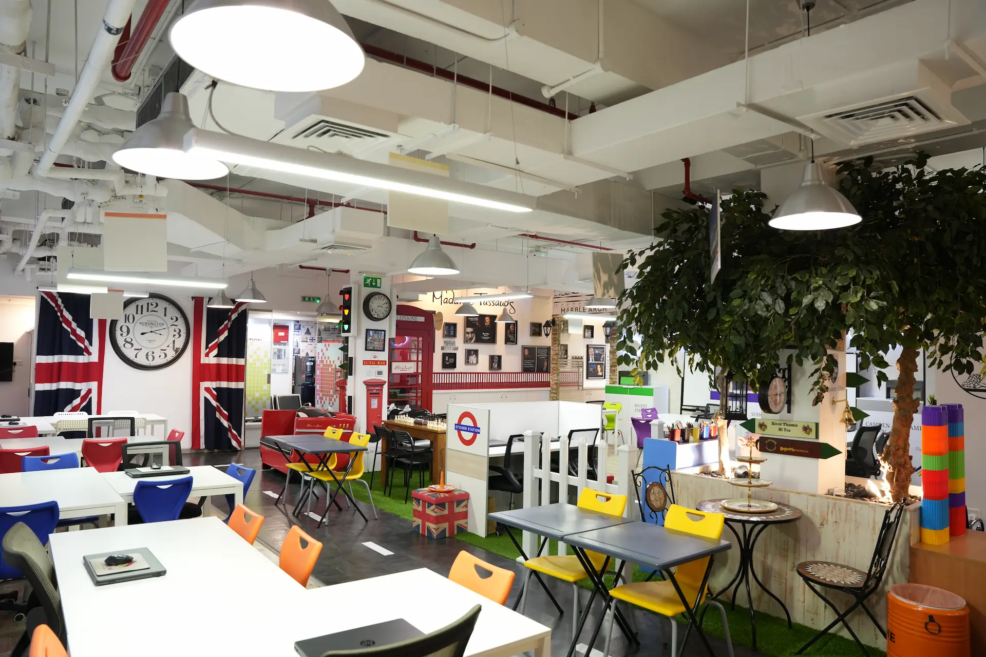Vibrant London-themed creative office with Union Jacks and a red telephone booth.